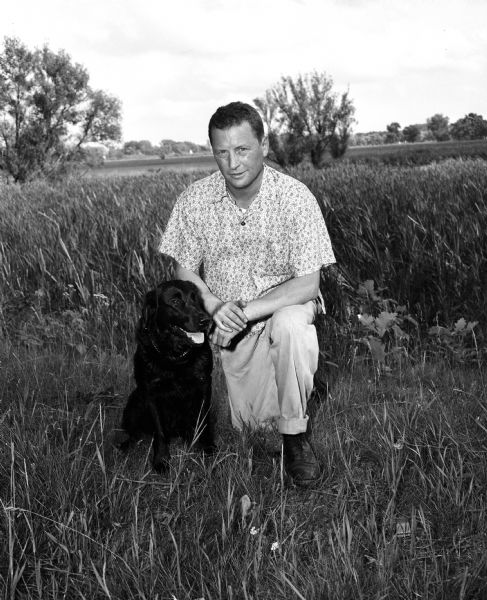 William Johnson of Green Bay is shown with his dog, Northwest Max. The dog was a champion in the Wisconsin Retriever field trials at Westport.