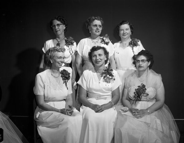 Group portrait of newly installed officers of Women of the Moose. Left to right, first row, are: Clara Sheets, junior graduate regent; Arlene Frazier, senior regent; and Marguerite Pien, junior regent. Standing in the back row are: Patricia Meyers, treasurer; Hazel Lerwick, recorder and Martha Belford, chaplain.