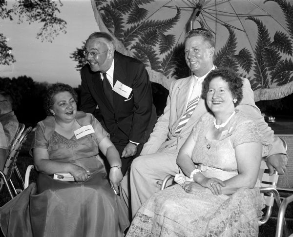 Mr. and Mrs. Lloyd Mapes (left) and Mr. and Mrs. Jalmer Raltson socialize at the East High School Reunion held at Maple Bluff Country Club. Both couples are residents of Washington D.C. and class of 1926 graduates.