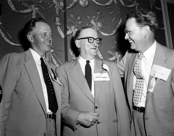 Men converse during the East High Class Reunion held at Maple Bluff Country Club. Shown left to right are: L.J. Larson, 919 Magdeline Drive, class of 1923; honored guest, Foster S. Randle, principal of East High from 1923 when it opened to his retirement in May of 1954; and Louis Odegard, 710 Ottawa Trail, also a 1923 grad.