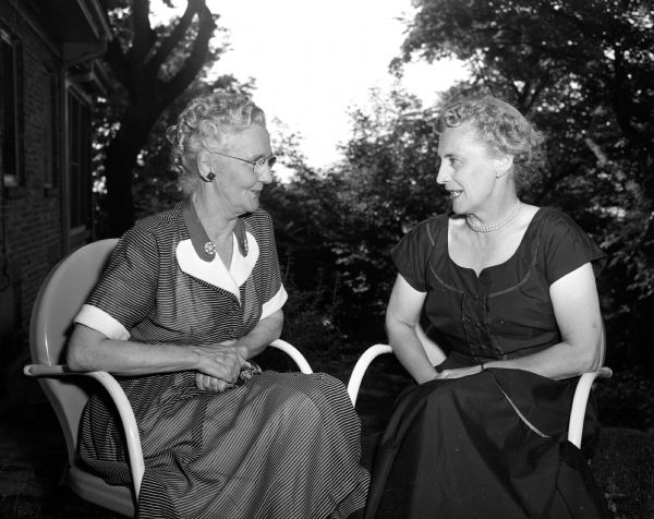 Mrs. Elleroy M. Smith (left), a Presbyterian missionary in China for more than 30 years, was guest of honor and speaker at a missionary tea given by the women of Christ Presbyterian Church. She and Eleanore Conlin (right) are sitting in lawn chairs and chatting. They are at Conlin's yard, 739 Farwell Drive in Maple Bluff.
