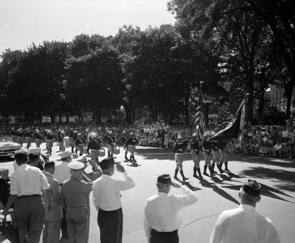 The Racine Post No. 76 drum and bugle corps receives a salute as they pass the reviewing stand during the American Legion parade around the Capitol Square. They were the winners of the Tournament of Music competition the previous night.
