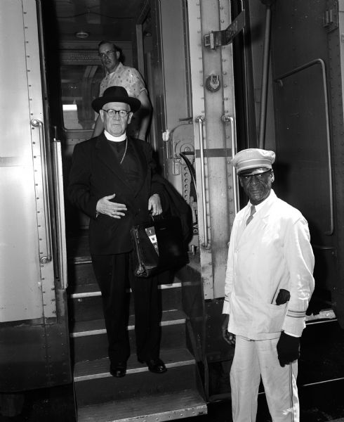 Catholic bishop of Madison William P. O'Connor steps off a train upon his return from two months traveling in Europe.