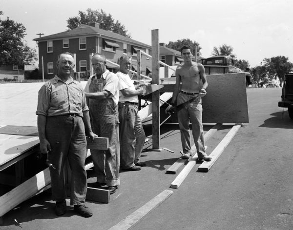 City parks personnel, left to right: Carl J. Schultz, Herbert Gorman, Daniel Finn and Richard Gilliard put up the starting ramp on South Midvale Boulevard for the 1954 soap box derby.