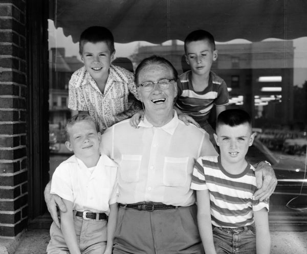 Shorewood Hills boys shown with "Roundy" Coughlin, <i>Wisconsin State Journal</i> columnist, after the presentation of money raised for Roundy's Fun Fund at the annual Shorewood Village festival. Back row left to right: David and Doug Todd. Front row: Gilbert Youmans, "Roundy," and Rich Shideman.