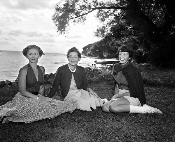 The 53rd annual Inland Lake Yachting Association Regatta hosted by the Mendota Yacht Club is held in Madison August 22, 1954. Pictured are three members of the social committee for the regatta: Phyllis Beck, Gertrude Adams, and Patricia Neff.