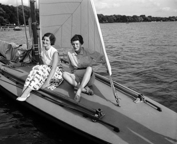 Jane Botham (left) and Helen Hanks (right) plan to assist with registration and administrative tasks for the 53rd annual regatta of the Inland Lake Yachting Association. They are sitting on a boat in Lake Mendota.