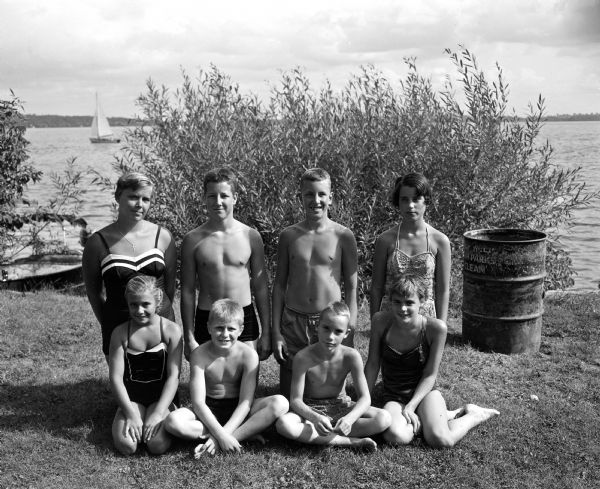 Group portrait of the winners of the diving competition at the annual city swimming meet held at B.B. Clarke beach. Front row, left to right: Tia Nelson, Don Foster, Bill Jasper and  Jane Ragsdale.  Back row: Mary Nelson, Steve Weiss, Stuart Gordon, and Mimi Hastings.
