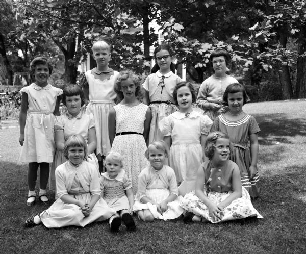 Group portrait of 12 girls taken outdoors. Taken for Carol F. Findorff, 25 Cambridge Court, Maple Bluff.