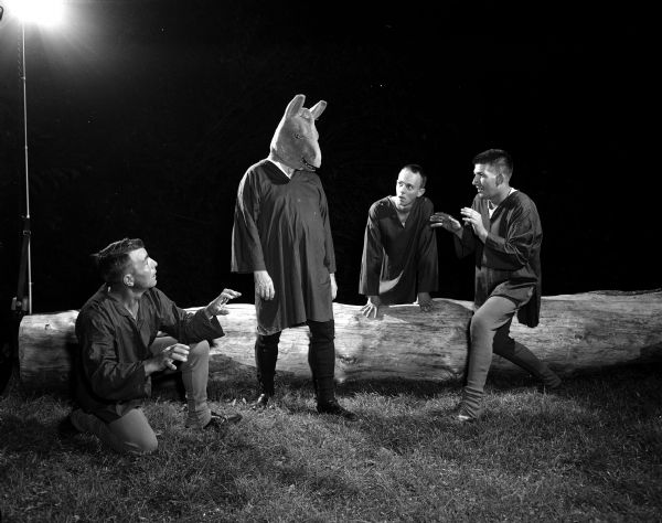 A scene from the Mineral Point Players' production of Shakespeare's "A Midsummer Night's Dream". John Walsh wears an ass's head while enacting the role of Bottom. Other actors, left to right, are Ernie Springer, Dick Martin Jr., and James Dolan.
