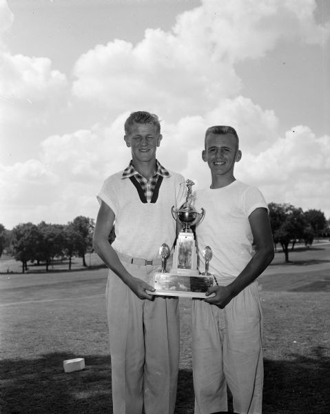 Don Quam and Don Christianson, captains of the Nakoma team that won the team title at the Madison Inter-Club Junior Golf Tournament, hold the traveling trophy.