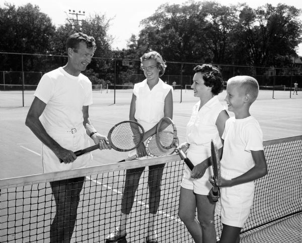 Professor C. Harvey and Mrs. (Emma) Sorum of 938 University Bay Drive, and their children Jean, 15, and Paul, 11, like to play tennis together at the University of Wisconsin tennis courts.
