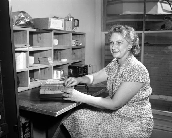 Mabel Huffman checks mailing files for union activities for the "Union Labor News." She is a leader in labor activities in Madison.