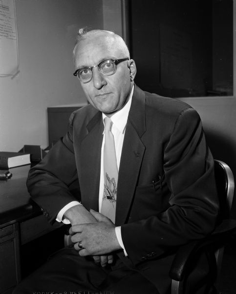 Portrait of John R. Wrage, general campaign manager of the 1954 United Givers Campaign, as well as personnel director and assistant vice-president at Gisholt Machine Company. After a career in education, Wrage started as a machine operator at Gisholt in 1941; he was vice-president by 1954.