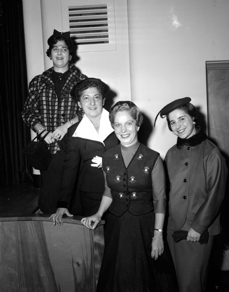 Group portrait of members who served as models in the style show at the Membership Tea of B'nai B'rith of Madison, a Jewish service and charitable organization. They are, from left to right: Mrs. Melvin Simons, Mrs. George Stewart, Alice Simins and Nadine Shapiro.