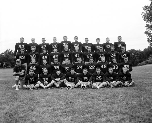 Coach Earl Wilke, left, kneels in the second row, amongst the 37 players of the Edgewood High School football team.