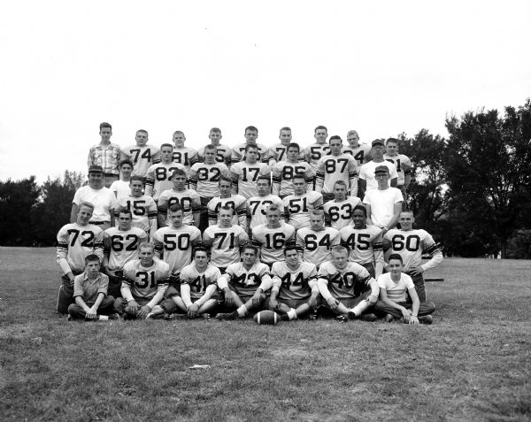 Group portrait of the Madison West High School football team with coach Fred Jacoby. They won a share of the Big Eight crown with Racine Horlick.