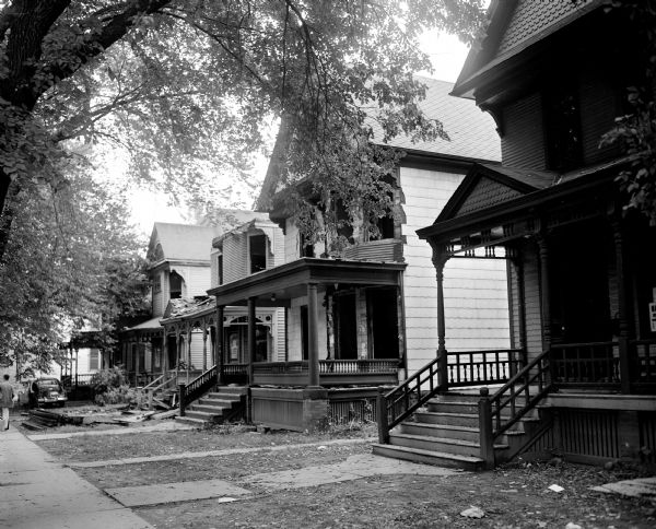 Exterior view of four houses, probably in the 400 block of North Lake Street, to be torn down for the Lake Street parking ramp.