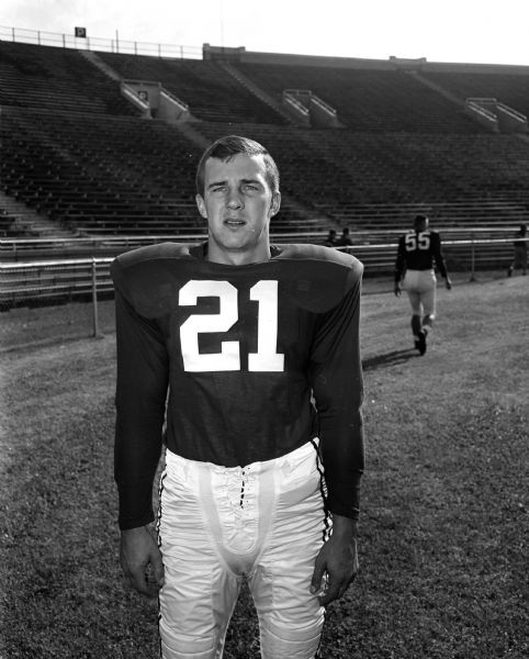 Portrait of Jim Miller, #21, a University of Wisconsin football player in uniform.