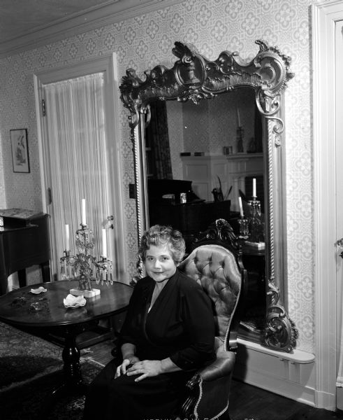 Eleanor Riley Grant sitting in the living room of the Frank Riley house, 2925 Oakridge Avenue, one of the homes on the benefit tour for the League of Women Voters. Mrs. Grant is the late Frank Riley's niece; she lives in the home with her parents Charles and Grace Riley.