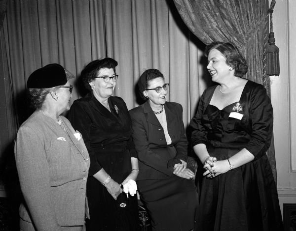 An unidentified woman (left), Mrs. William R. (Helen) Winner, representing the Dane County Veterinary Medical Auxiliary, and Mrs. Louis (Idella) Knickmeyer of Zion Lutheran Church visit with Louise C. Marston (right), society editor of the <i>Wisconsin State Journal</i> during the journal's publicity workshop.