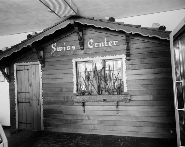 "Swiss Center," a false building front in the style of a Swiss chalet taken for Swiss Center, a Wisconsin natural cheese gift box mail order company located at 2805 University Avenue.