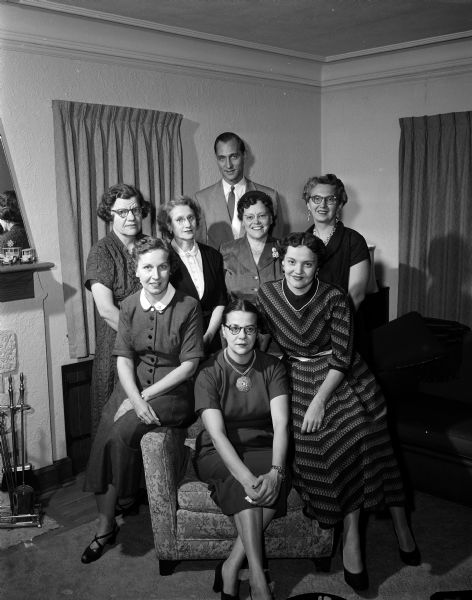 Group portrait of the committee members making arrangements for the fall fashion show of the West Side Business Men's Auxiliary include, left to right, in front row: Mrs. Karl (Ruth) Rentschler, Mrs. Curtiss (Irma) Brauhn and Mrs. Harry Stoll. In the second row are, Mrs. Donald Helen) Napper, Mrs. Edward (Madeline) Kingston, Mrs. E.C. (Marie) Meiller and Mrs. Cosmo (Mary) DiSalvo. Harry Stoll is standing in back of the women.