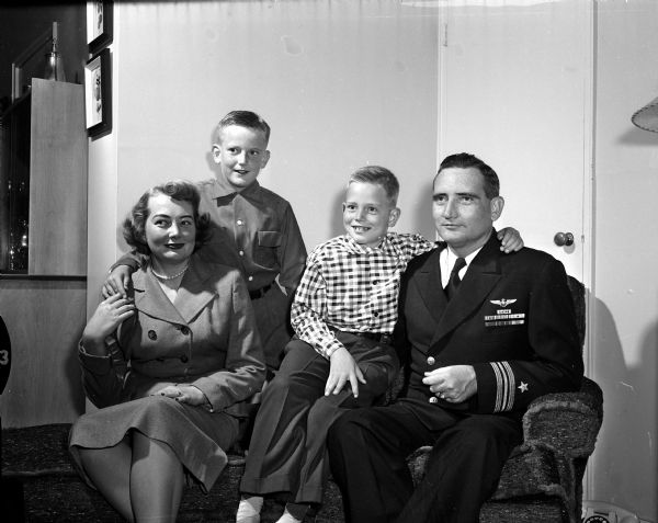 Portrait of Lieutenant Commodore Robert J. Murphy, Navy ROTC, (right) with Mrs. Murphy, and their sons David, age 9, and Thomas, 7.