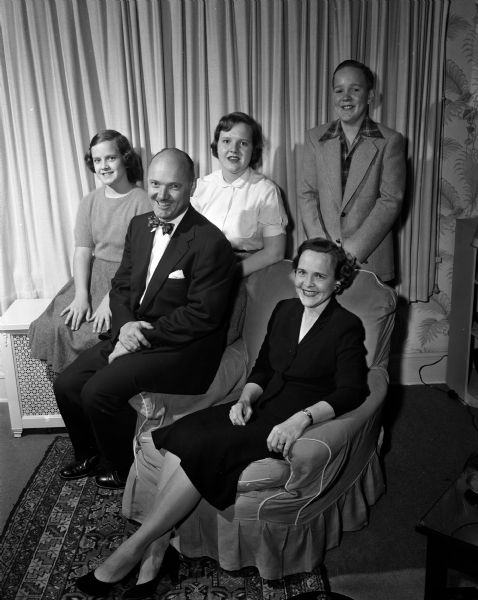 Portrait of Dr. Vernam Terrell Davis, assistant director of the division of mental hygiene at the Diognostic Center and associate professor of clinical psychiatry at the University of Wisconsin Medical School. Also shown are his children Nancy, age 11, Judy, 15, and John, 13, and his wife Mrs. Davis.