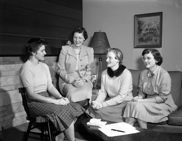 Mrs. William F. (Ann) Rundell (left) of 4320 Hillcrest Circle, chairman of the Dane County Dental auxiliary project committee, sits with three of her assistants while discussing plans for the auxiliary's first fund-raising project. They include, from left: Mrs. James (Virginia) Namio of 1430 Chandler Street, Mrs. H. R. (Jane) Dickert of 2423 Norwood Place, and Mrs. C. E. (Joan) Schram of 1001 Rutledge Street.