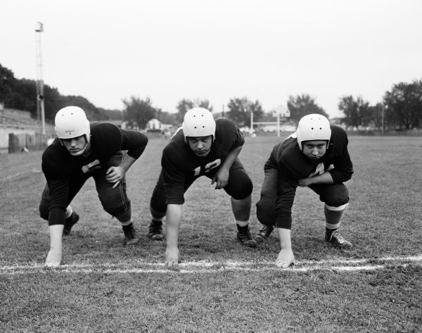 Playing in the Jefferson vs. Wisconsin High School football game are Jefferson defensive linemen Bob Seitz (left), John Edwards, and Dick Krueger.