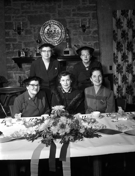 Group portrait of the officers of the Women's Auxiliary of the Wisconsin Veterinary Medical Association during a meeting at Nakoma Country Club. Seated left to right: Helen Winner, Madison; Mrs. Elmer Woeffler, Oconomowoc; and Mary Brandly, Madison. Standing:  Mrs. W.A. Thomson, Platteville, and an unidentified woman.