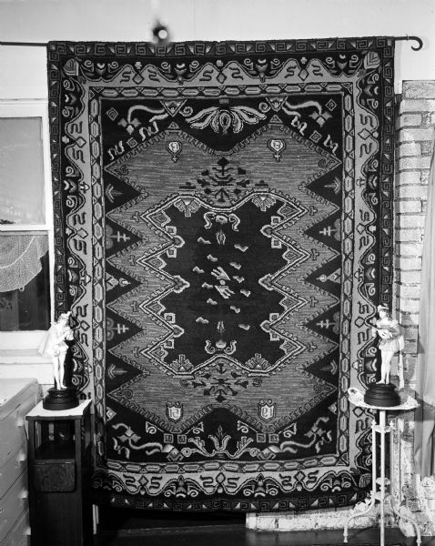 View of Edna Bullard's latest hooked rug hanging on the wall at her home. It was her 35th creation.