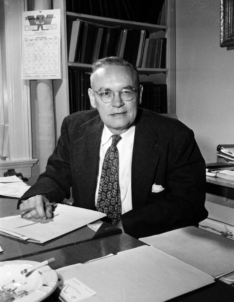 Portrait of Theodore Zillman sitting at his desk. Zillman is the University of Wisconsin Dean of men.