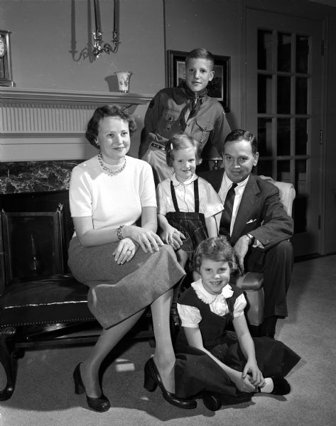 One of Madison's "Red Feather families" are Mr. and Mrs. Robert W. (Nancy) Anthony, Jr. of 3512 Blackhawk Drive in Shorewood Hills are one of Madison's "Red Feather Families." They are shown with their three children: Tony, 12, is a Boy Scout, Anne, 8 1/2, is a Brownie Girl Scout, and Deborah, 5, sits on her father's lap.
Mr. Anthony is associate chairman of the 1954 United Givers' Fund and a member of the board of directors of the YMCA and Mrs. Anthony serves on the board of the Dane County Child Guidance Center and is a member of the Visiting Nurse Society and the Children's Service Society.
The United Community Chest benefits 24 separate Red Feather agencies.