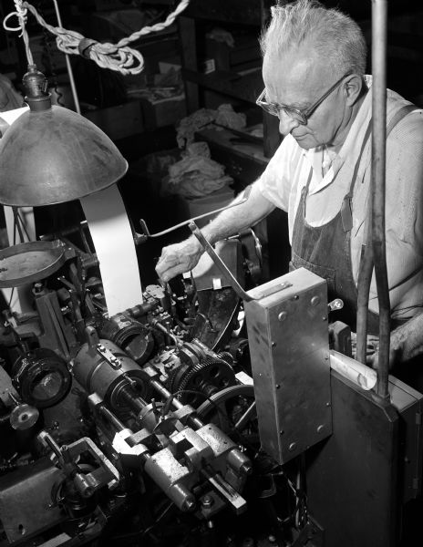 Edwin Koch demonstrates the paper cup making machine he invented as a retirement project.