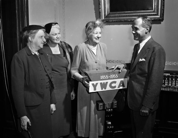 Group portrait of four of the six members of a Madison group named to be part of the National YWCA Citizens' committee for observance of the YWCA centennial celebration. Pictured left to right: Rosa Fred, Mary Rennebohm, Lois Rosenberry, and Governor Walter Kohler.