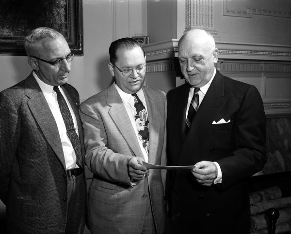 University of Wisconsin President E.B. Fred receives a check from Dr. Robin Allin of the Wisconsin Heart Association. Looking on is John Wrage, chairman of the United Givers' Fund.