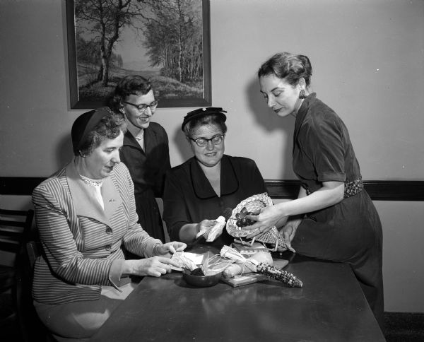 Four parents and teachers are shown making preparations for the observance of Education Week at East High School. From left to right are, Mina Sperling, Edith Olson, Leila Engel, and Marjorie Schafter.