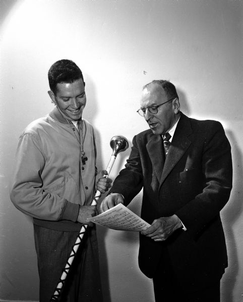University of Wisconsin marching band drum major Stanley Stitgen of Madison confers with band director Raymond F. Dvorak about the performance at the homecoming football game.
