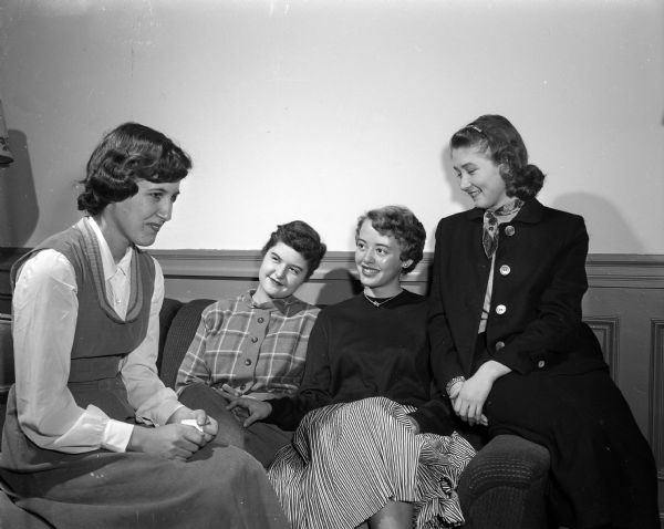 Four members of the YWCA Y Teens group converse while seated.
