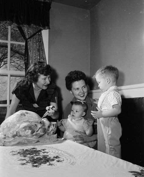 Michael Stebbins, 22 months; Patricia Stebbins, 8 months; Mrs. George G. Stebbins, Jr., mother; Bernice Stebbins, grandmother celebrate a three-generational Thanksgiving at the Stebbins' home.