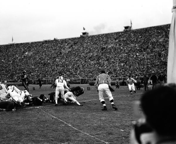 Alan Ameche scores a touchdown during his last game at the University of Wisconsin. The team was playing football against the University of Minnesota.
