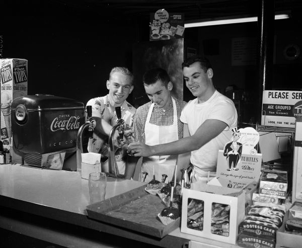 Three Edgewood High School students work after school hours at Mickie's Dairy Bar on Monroe Street in Madison. From left are Frank Hebl, Frank's brother Bill Hebl, and Terry Plummer.