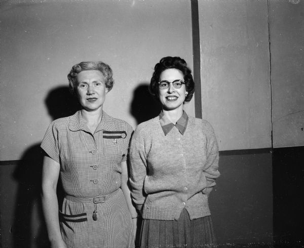 Portrait of league high scorers, Marie Geisler and Val Schwoegler. They bowled in the West Side Business Men's Association Auxiliary League at Schwoeglers Lanes at 437 West Gilman Street. Mrs. Geisler wears a 'lucky' rabbits foot hanging from her belt buckle.