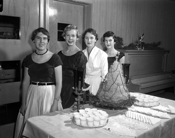 Four Wisconsin High School sophomore girls, co-hostesses for a holiday dancing party at Blackhawk Country Club, include, from left to right: Gill Wolff, Judy Angevine, Gail Mosely, and Nancy Stein.