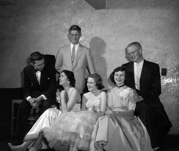 Group portrait of three couples attending the formal dance at Nakoma Country Club. The girls, left to right, are: Helen Stuben, Virginia Wallace, and Marlene Wieland. The boys are John Lonergan, Paul Treichel, and Thomas Lee.