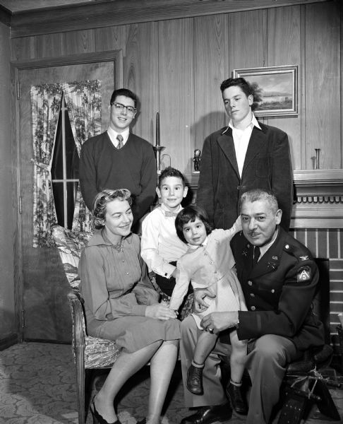 Family portrait of Humbert and Marie Versace with their four children. Colonel Versace, a West Point graduate, is senior advisor for the Wisconsin National Guard. Marie, as Tere Ríos, is the author of several short stories which have appeared in leading American magazines.