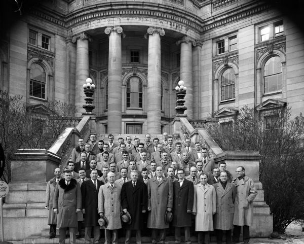 Group portrait of the members of the Safety Division of the Motor Vehicle Department gathered on the Capitol Building steps.