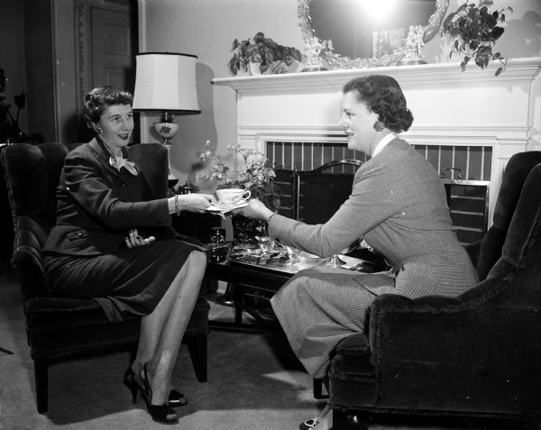 Mrs. W.J. (Isabel) Peterson (left) of 815 Hiawatha Drive, script-writer, and Mrs. Paul (Corinne) Geisler of 4026 Council Crest, director, talk over their plans for "Father Knows Best", written for the annual benefit welfare show produced by the West High School PTA.